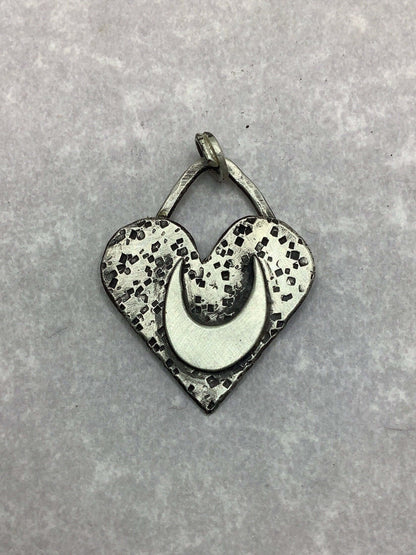 silver heart charm on blank background