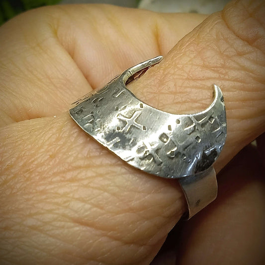 Large crescent moon ring on thumb